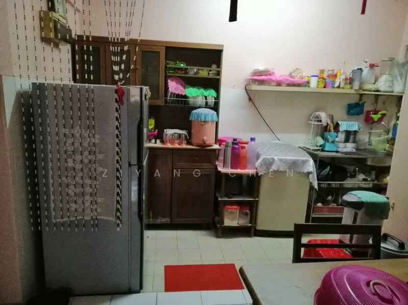 Kitchen features: stainless-steel fridge, wood cabinetry, countertop with sink, kitchen appliances visible, ceramic tile flooring, beaded curtain, red area rug, multiple storage containers, wall-mounted shelves.