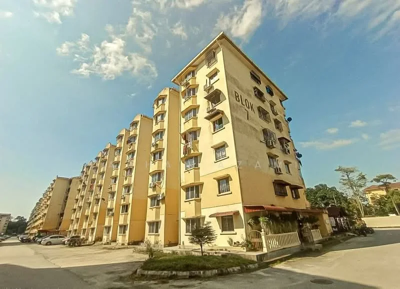 Exterior type: low-rise apartment block; features: yellow painted facade, 5-storey building, multiple windows with grilles, balconies on upper floors, flat roof, manicured landscaping in front, parking area visible, surrounded by greenery; style: modern.
