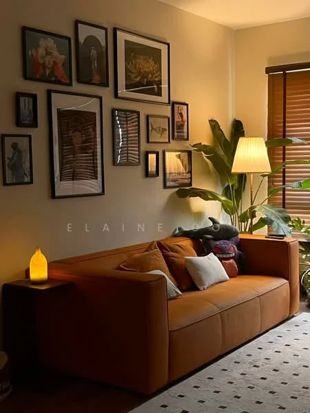 Living features: orange fabric sofa, decorative cushions, wooden side table, framed artwork on walls, indoor plant, floor lamp, wooden blinds, area rug with geometric pattern, neutral wall color, laminate flooring; style: modern.