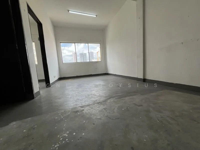 Room features: white painted walls, concrete flooring, large window with city view, fluorescent ceiling light, no visible furniture or decor; style: minimalist; view: city.