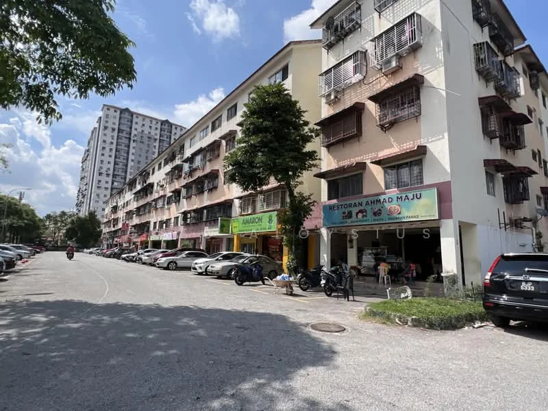 Exterior type: shophouse; features: 3-storey shophouse, ground floor commercial units, balconies with metal railings, signage for restaurants and shops, parking spaces along the street, trees lining the street, residential apartments above commercial units, visible vehicles parked, sidewalk area for pedestrians; style: modern.