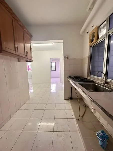 Kitchen features: white tiled walls, white tiled flooring, brown wooden upper cabinets, double-bowl stainless-steel sink, gas stove with two burners, window with metal frame, exhaust fan, open layout to adjacent room.