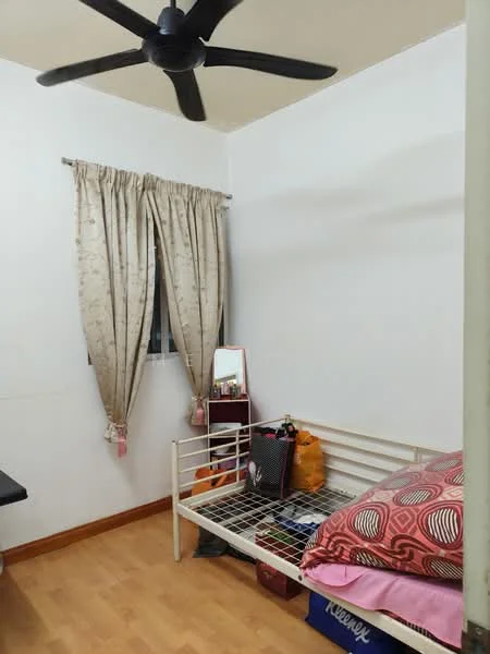 Bedroom features: wooden flooring, white painted walls, ceiling fan, curtains, single bed frame, bedding with patterned design, mirror, small dresser, storage bags, window, decorative items.
