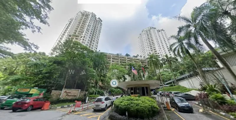 Exterior type: high-rise condominium; features: two high-rise buildings, landscaped entrance with greenery, manicured lawn, paved driveway, multiple parked cars, security guardhouse at entrance, flag poles with flags, surrounding palm trees, multi-storey car park, modern architectural design; style: modern.
