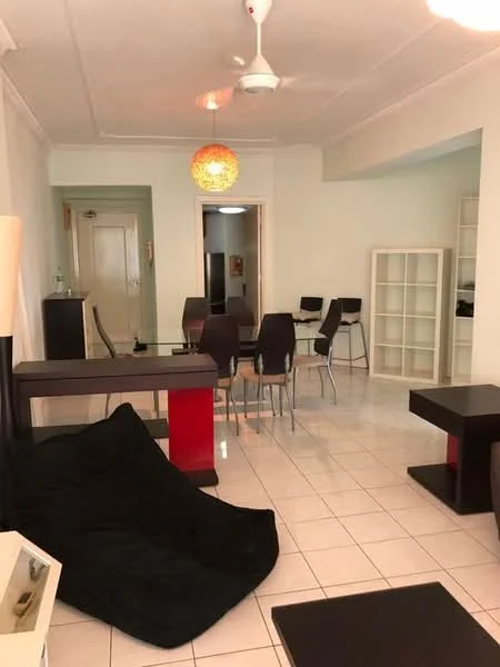 Living features: white painted walls, glossy tile flooring, 5-blade ceiling fan with light, pendant light fixture, black bean bag chair, black coffee table, red accent table, dining table with four chairs, open shelving unit, doorway leading to hallway; style: modern.