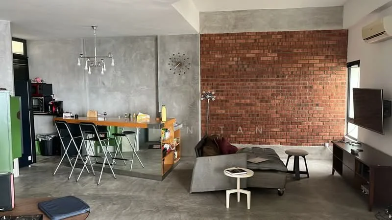 Living features: exposed brick accent wall, grey concrete walls, polished concrete flooring, ceiling with recessed downlights, wall-mounted TV, dark wood TV console, sofa in grey fabric, coffee table, floor lamp, clock on wall, open-plan layout with kitchen, bar counter with stools; style: industrial. Kitchen features: stainless-steel fridge, built-in oven, black cabinetry, kitchen island with bar stools, sink, countertop, microwave, open shelving; style: industrial.