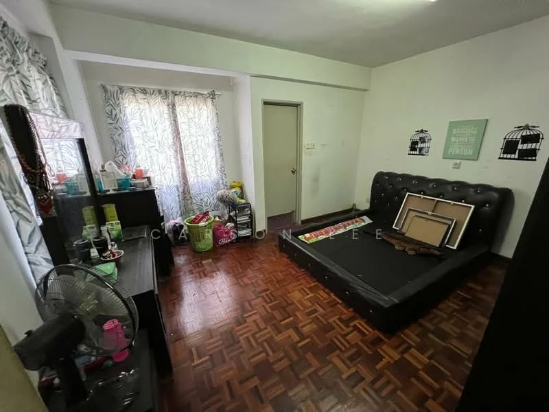 Bedroom features: parquet wood flooring, black upholstered bed frame, decorative wall art, window with sheer curtains, black dresser, wall-mounted mirror, door to hallway, ceiling light fixture, fan, various personal items on dresser.