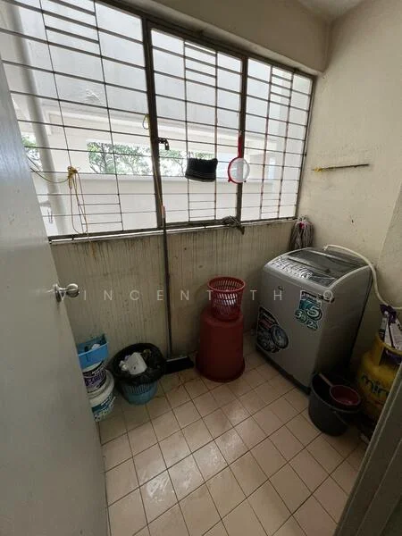 Laundry features: washing machine, window with metal grille, tile flooring, plastic laundry basket, plastic storage bins, red plastic container, cleaning supplies, exposed concrete walls.