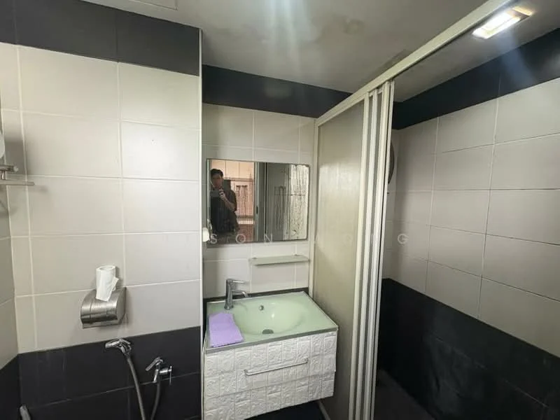 Bathroom features: white tiled walls, black tiled walls, glass shower enclosure, single-sink vanity with white cabinet, mirror above sink, chrome basin mixer faucet, toilet paper holder, towel rack, shower head, handheld shower, purple bath mat; style: modern.
