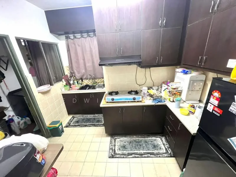 Kitchen features: dark wood cabinetry, white tiled backsplash, stainless-steel gas hob, black refrigerator, white countertop, kitchen sink, floor tiles, two area rugs, window with sheer curtains, wall-mounted kitchen appliances, various kitchen utensils and containers; style: modern.
