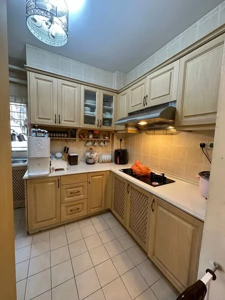 Kitchen features: light wood cabinetry, white countertop, built-in oven, stainless-steel range hood, 4-burner gas hob, double-bowl stainless-steel sink, tile backsplash, ceramic tile flooring, recessed lighting, kitchen appliances, open shelving, wall-mounted cabinets, pantry storage, window with sheer curtains; style: traditional.