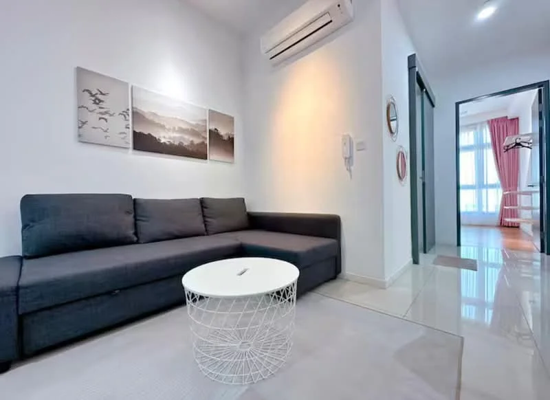 Living features: L-shape sectional sofa in dark grey, white round coffee table, wall-mounted air conditioning unit, light-colored tiled flooring, white painted walls, framed artwork on the wall, floor-to-ceiling windows, curtains in light pink, decorative mirror, recessed ceiling lights; style: modern.