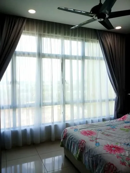 Bedroom features: king-size bed, floral patterned bedding, floor-to-ceiling windows, sheer curtains, dark grey curtains, 5-blade ceiling fan, glossy tile flooring, wall-mounted light fixtures; style: modern; view: garden.