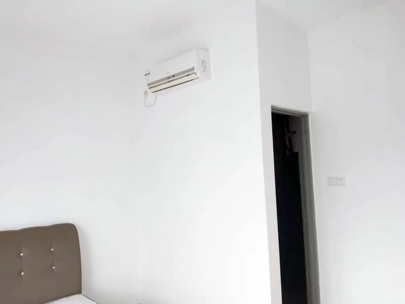 Room features: white painted walls, wall-mounted split AC, doorway leading to another room, bed with upholstered headboard.