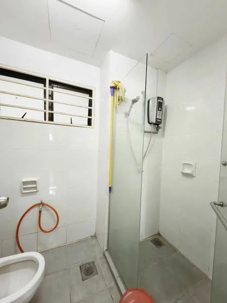 Bathroom features: white tiled walls, grey tiled flooring, walk-in shower with glass enclosure, chrome shower head, handheld shower, toilet, wall-mounted shower control, small wall-mounted shelf, window with metal grilles, shower curtain rod, drain in floor; style: modern.