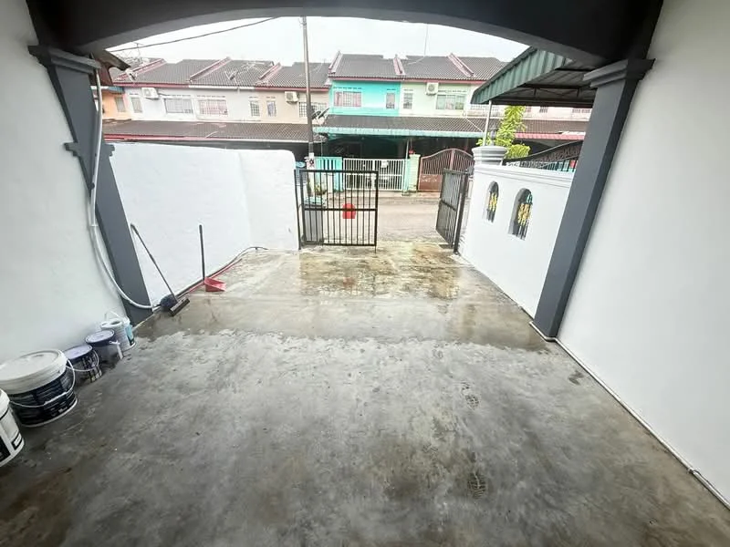 Exterior type: linked terrace house; features: concrete driveway, white painted walls, metal gate, paved surface, surrounding fence, outdoor space, drainage system, no visible landscaping; style: modern.