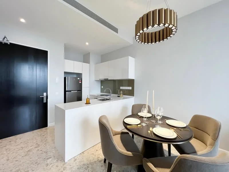 Kitchen features: white cabinetry, stainless-steel fridge, built-in oven, ceramic cooktop, grey backsplash, white countertop, single-bowl stainless-steel sink, chrome pull-down faucet; style: modern. Dining features: round dining table, 4 upholstered dining chairs in grey, decorative candle holder, table setting with plates and glasses, chandelier light fixture; style: modern.
