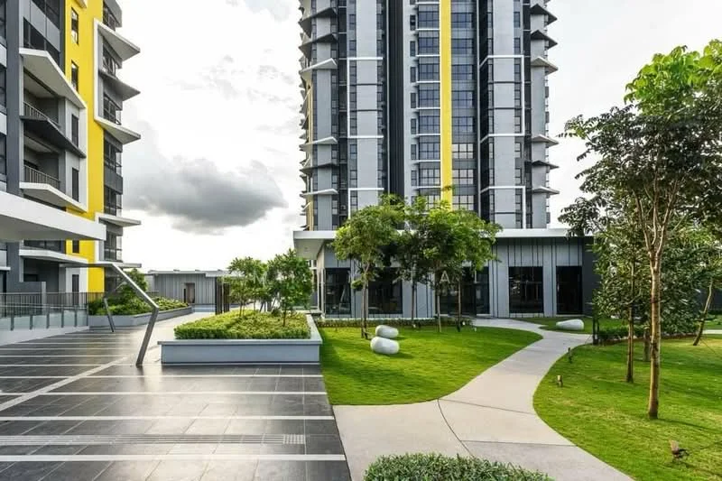 Exterior type: high-rise condominium; features: modern facade with yellow accents, glass curtain wall, landscaped garden with manicured lawn, pathway with curved design, decorative stones in garden, multiple trees and shrubs, outdoor seating area, balconies on upper floors, parking area with paving, surrounding greenery; style: modern.