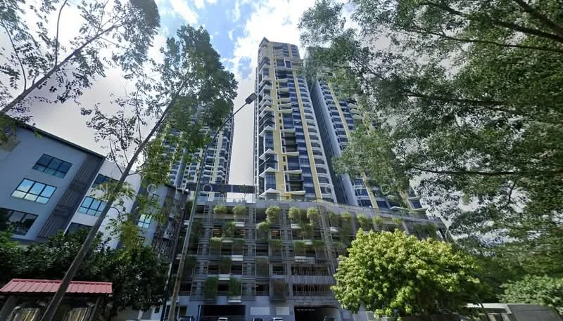 Exterior type: high-rise condominium; features: glass curtain wall, greenery on balconies, multiple storeys, surrounded by trees, modern architectural design, visible parking area, elevated entrance, outdoor landscaping; style: modern.