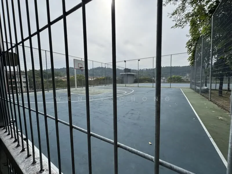 Exterior type: basketball court; features: outdoor basketball court, fenced perimeter, two basketball hoops, multi-court layout, concrete flooring, surrounded by greenery, mountain view in background, daylight, open sky; style: modern.