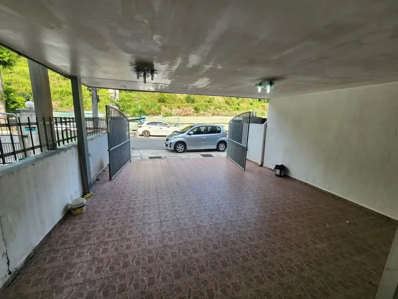 Exterior type: car porch; features: paved flooring, two ceiling lights, open space, gated entrance, surrounded by greenery, wall with white paint; style: modern.