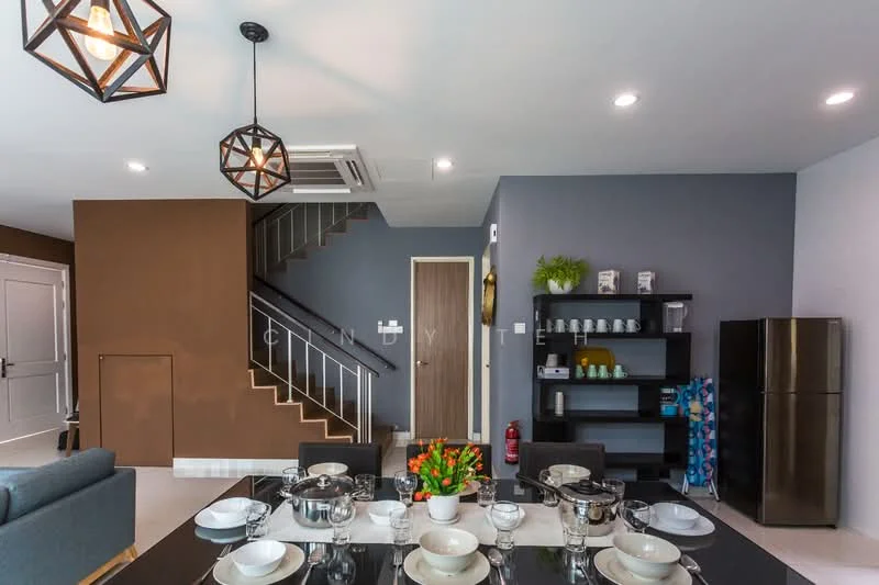 Dining features: 6-seater dining table, black dining chairs, decorative centerpiece with flowers, pendant lighting fixtures, recessed LED downlights, open shelving unit, stainless-steel fridge, wall-mounted air conditioning unit, grey accent wall, cream painted walls, staircase with metal railing, floor tiles, fire extinguisher; style: modern.