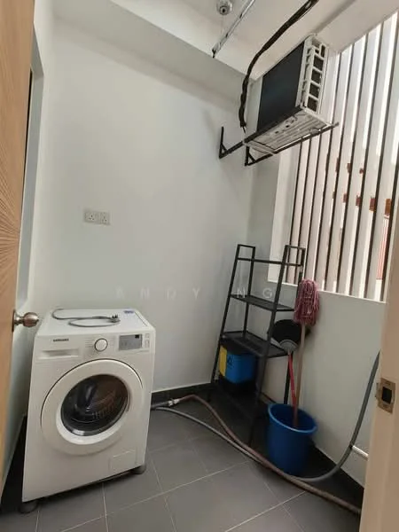 Laundry features: front-load washing machine, wall-mounted split AC, grey tile flooring, white painted walls, open shelving unit, blue bucket, mop, drainage hose.