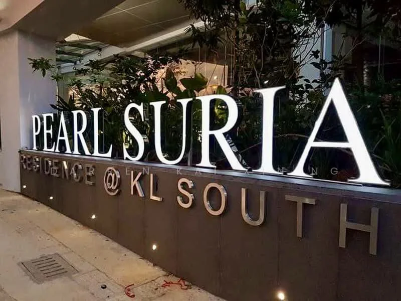 Exterior features: illuminated signage, landscaping with plants, modern facade, stone cladding, concrete structure, outdoor lighting; style: modern.