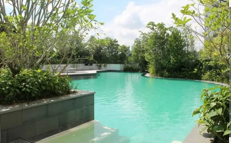 Exterior type: swimming pool deck; features: infinity pool, landscaped garden, tropical landscaping, mature trees, stone-paved walkway, pool deck with loungers; style: modern.