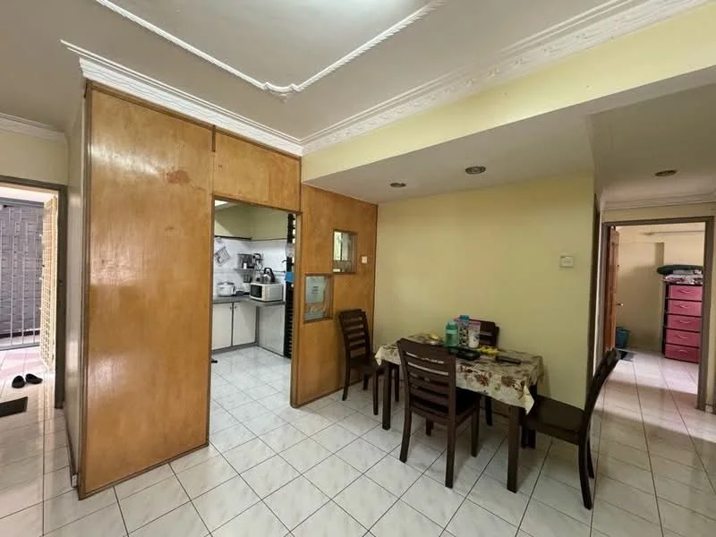 Dining features: dining table with floral tablecloth, 4 wooden dining chairs, white tiled flooring, cream painted walls, crown moulding, recessed ceiling lights. Kitchen features: white cabinetry, stainless-steel sink, built-in stove, microwave, refrigerator, tile backsplash, grey countertop. Room features: doorway leading to another room, light beige walls, white ceiling.