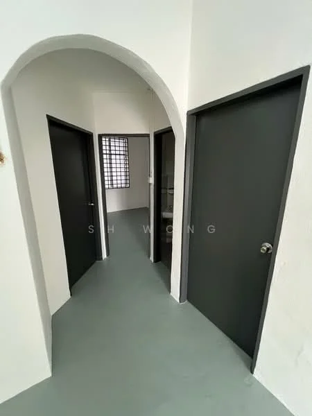 Room features: arched doorway, white painted walls, grey flooring, two dark doors, window with grid pattern, neutral color scheme; style: modern.