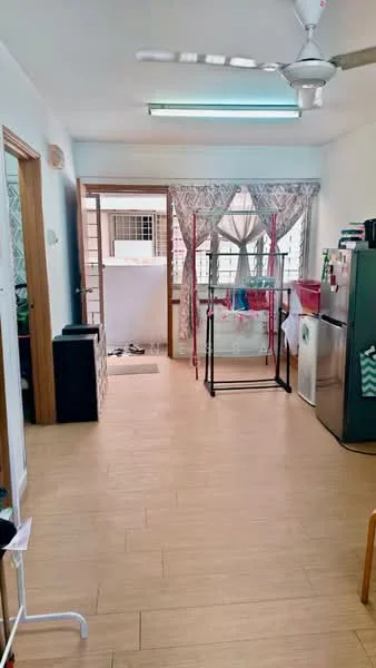 Kitchen features: light wood laminate flooring, white painted walls, ceiling fan with light, refrigerator, clothes drying rack, window with sheer curtains, door leading to outdoor area, kitchen counter, sink, dish rack; style: modern.