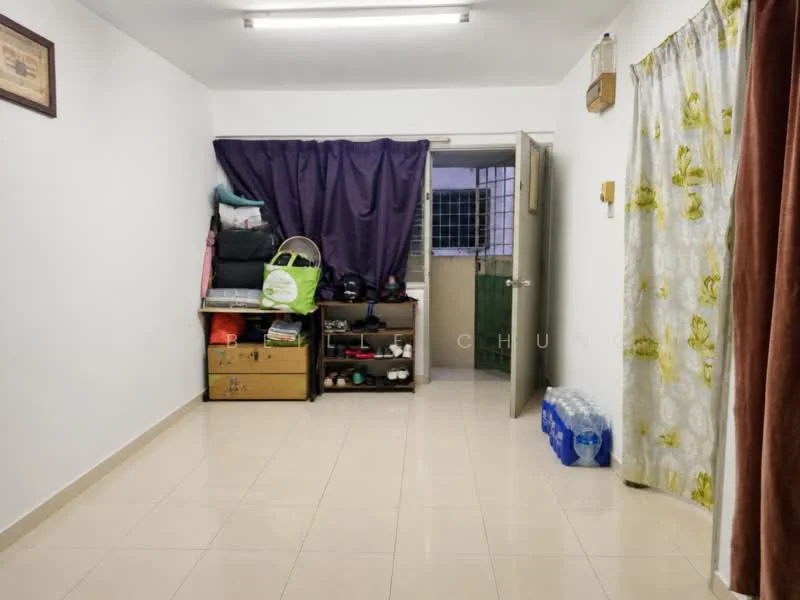 Room features: white painted walls, cream tiled flooring, ceiling lights, curtains with floral pattern, shelves with storage boxes, door leading to another room, water bottles stacked, dark purple curtain, green wall visible through the door; style: modern.