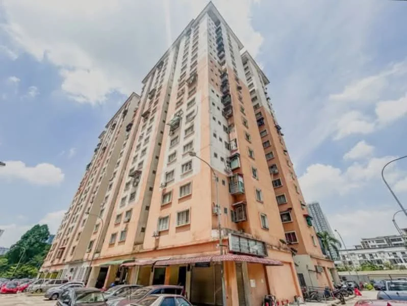 Exterior type: mid-rise condominium; features: orange painted facade, balconies with metal railings, multiple air conditioning units visible, ground floor retail space, parking area with cars, surrounded by greenery, urban context with nearby buildings; style: modern.