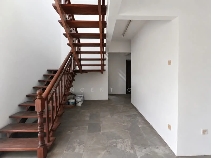 Room features: wooden staircase with handrail, grey stone flooring, white painted walls, recessed lighting, open space layout, corner wall with no visible features, paint buckets visible, natural light from windows; style: modern.