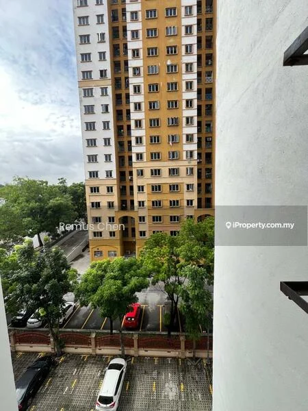 Exterior type: high-rise condominium; features: yellow and white painted facade, multiple storeys, balconies visible, surrounded by trees, parking lot visible, red car in parking lot, white cars in parking lot; style: modern.