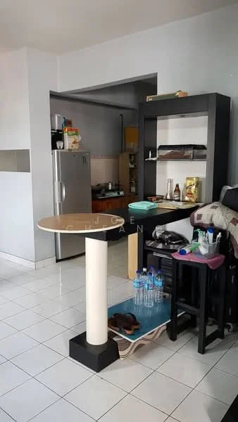 Room features: white painted walls, ceramic tile flooring, refrigerator, open shelving unit, small round table, black dining chairs, bottled water, kitchen area visible in background, countertop with kitchen items; style: modern.