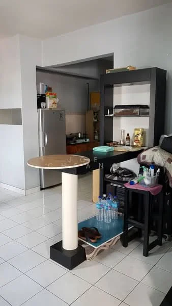 Kitchen features: white painted walls, ceramic tile flooring, kitchen island with circular top, black shelving unit, stainless-steel fridge, wooden cabinets, countertop with utensils, water bottles on floor, black dining chairs, decorative items on shelves; style: modern.