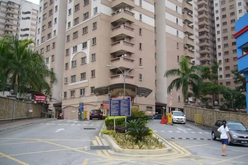 Exterior type: mid-rise condominium; features: cream painted facade, recessed balconies, entrance with awning, landscaped garden with plants, paved driveway, signage at entrance, surrounded by palm trees, multiple storeys, visible parking area; style: modern.