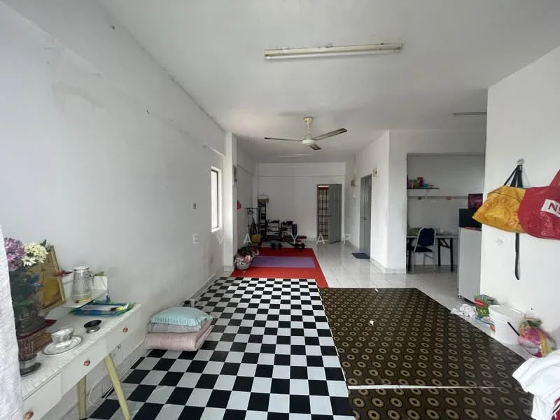 Room features: white painted walls, ceiling with fluorescent lights, 5-blade ceiling fan, black and white checkered flooring, brown patterned area rug, window with natural light, open layout, various items and furniture scattered; style: minimalist.