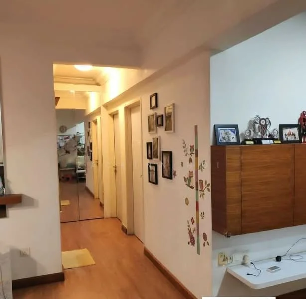Room features: wooden flooring, white painted walls, ceiling lights, mirror on wall, decorative wall art, wooden wall-mounted cabinet, framed photographs on wall, doorways leading to other rooms; style: modern.