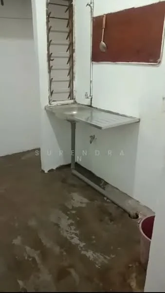 Laundry features: stainless-steel sink, metal countertop, exposed plumbing, white painted walls, concrete flooring, window with metal bars, drainage outlet, bucket, wall-mounted spoon holder.