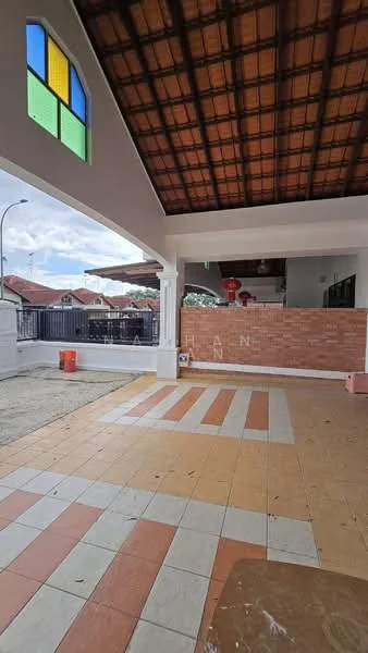 Exterior features: tiled flooring with orange, white, and beige patterns, exposed wooden ceiling, large window with colored glass panes, brick wall feature, open outdoor space, surrounding fence, visible street light, partially covered area; style: modern.