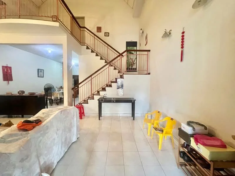 Room features: white painted walls, tile flooring, staircase with wooden railing, ceiling lights, open layout, decorative wall art, furniture including a console table, two yellow plastic chairs, dining area visible in background, fan, wooden furniture in background; style: modern.
