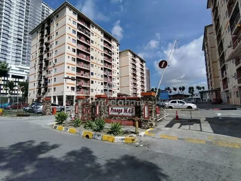 Exterior type: low-rise apartment block; features: pink painted facade, multiple storeys, balconies on upper floors, landscaped entrance with signage, paved driveway, surrounding palm trees, parking area, traffic barrier, road markings, surrounding greenery; style: modern.