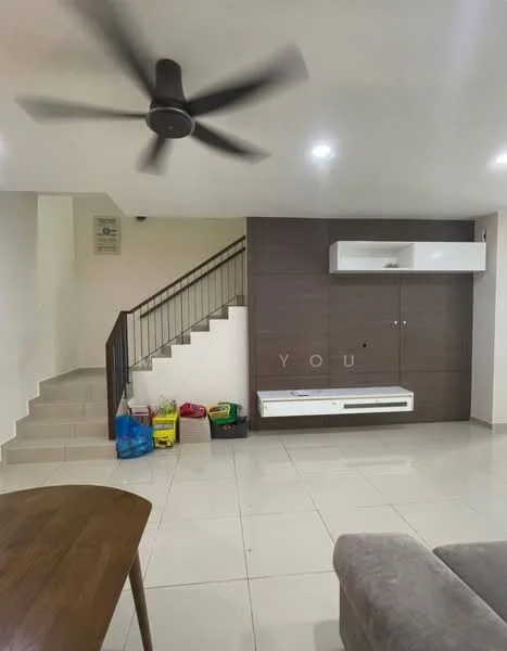 Living features: 5-blade ceiling fan, wall-mounted TV console, white wall-mounted storage unit, grey accent wall, light-colored tiled flooring, staircase with metal railing, open space layout, decorative items on console, seating area with sofa, natural light from windows; style: modern.