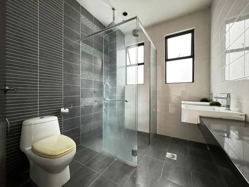 Bathroom features: walk-in shower with glass enclosure, rain shower head, handheld shower, single-sink vanity with wall-mounted faucet, white ceramic toilet, grey ceramic tile flooring, white tiled walls, dark grey accent wall, two windows with black frames, mirror above sink, towel rail, small potted plant on vanity; style: modern.