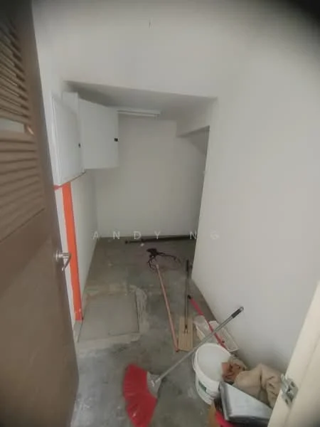 Room features: grey concrete flooring, white painted walls, wooden door, cabinets on wall, cleaning tools visible, sweeping broom, bucket, unfinished space.