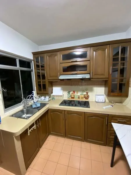 Kitchen features: brown wooden cabinetry, glass-front upper cabinets, cream countertop, stainless-steel sink, chrome pull-down faucet, built-in gas hob, exhaust hood, tile backsplash, window with grid design, orange tiled flooring; style: traditional.