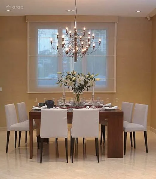 Dining features: rectangular wooden dining table, 6 upholstered dining chairs in light grey, chandelier with multiple bulbs, cream painted walls, large window with sheer curtains, marble flooring, decorative vase with flowers on the table; style: modern.